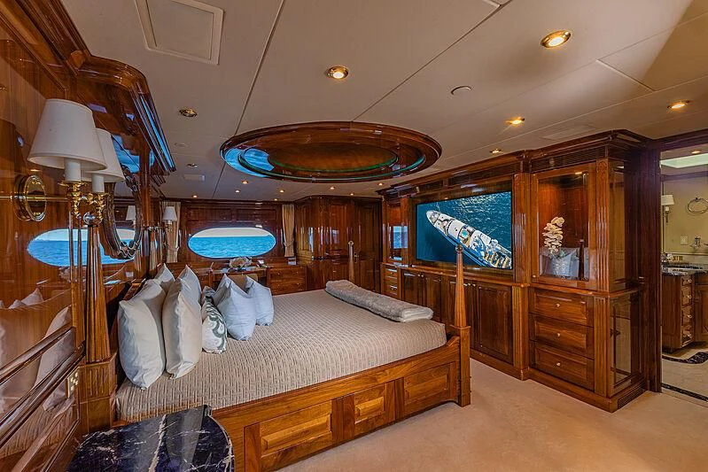 a bedroom with a large mirror aboard AMORE Yacht for Charter