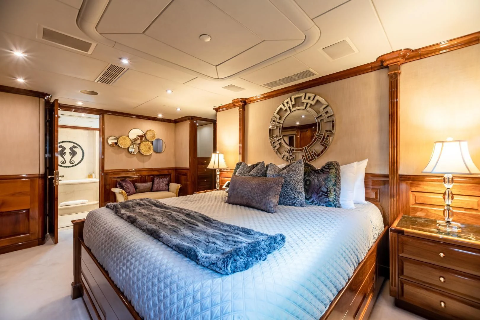 a large bedroom with a large round mirror aboard AMORE Yacht for Charter