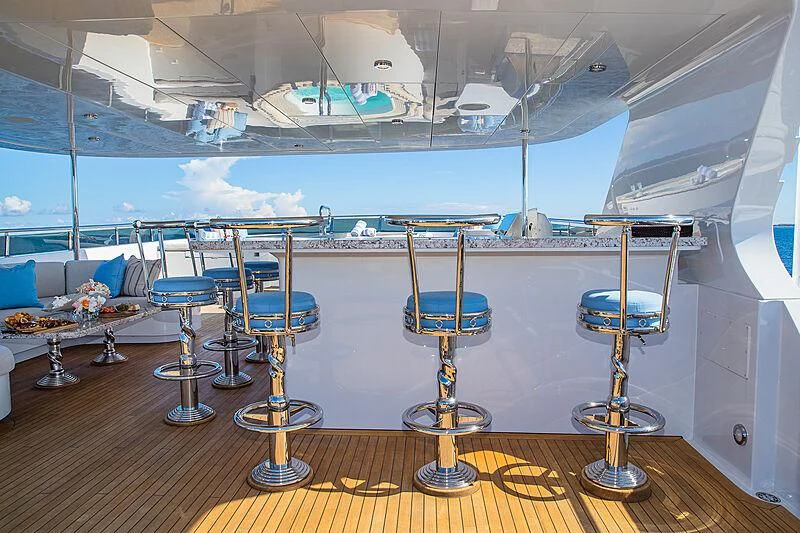a room with chairs and tables aboard AMORE Yacht for Charter