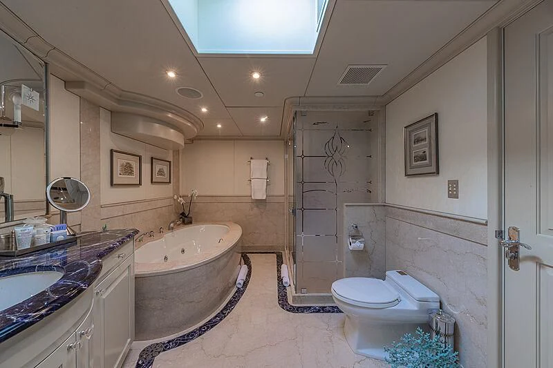 a bathroom with a tub sink and toilet aboard AMORE Yacht for Charter
