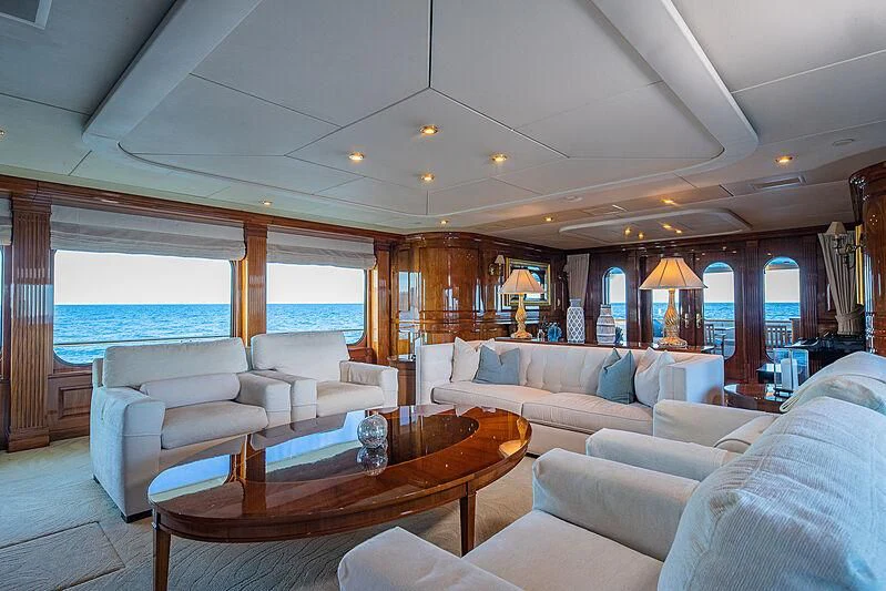 a living room with a table and couches aboard AMORE Yacht for Charter