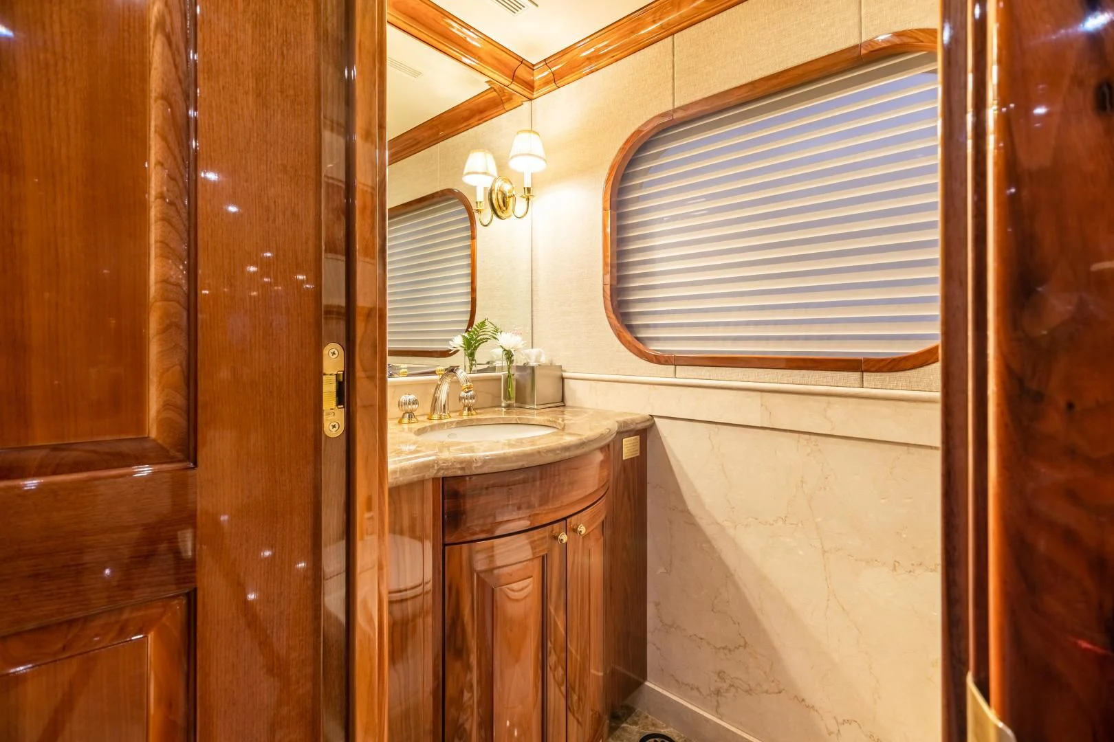 a bathroom with a sink and a window aboard AMORE Yacht for Charter