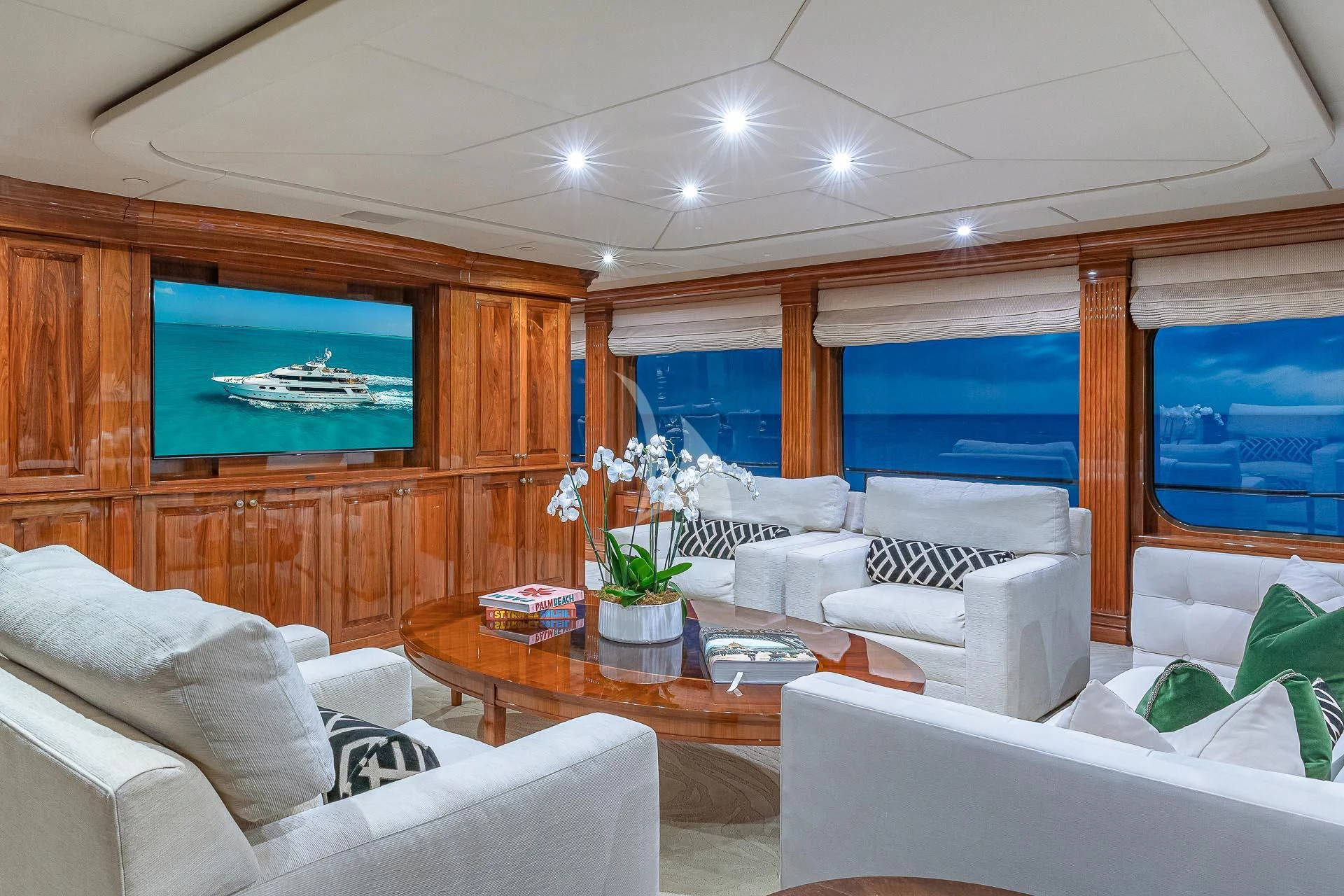 a living room with a large television aboard AMORE Yacht for Charter