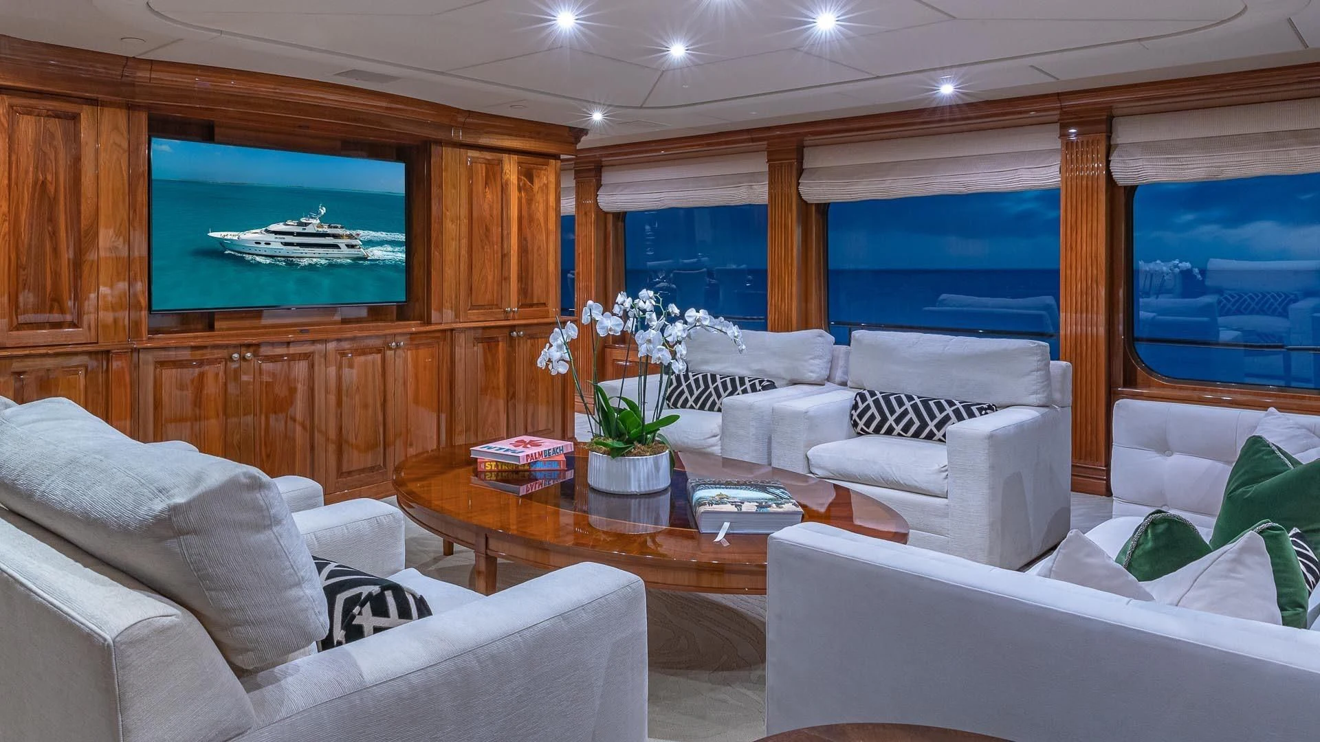 a living room with a large television aboard AMORE Yacht for Charter