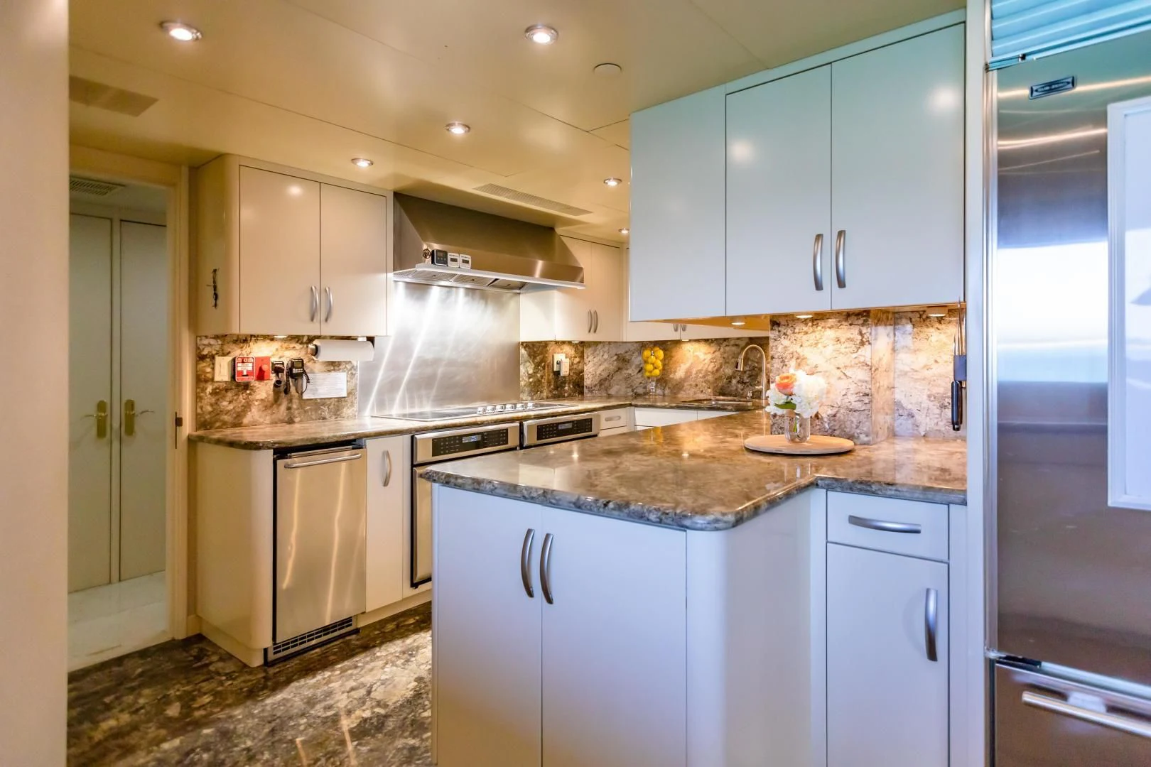 a kitchen with white cabinets aboard AMORE Yacht for Charter
