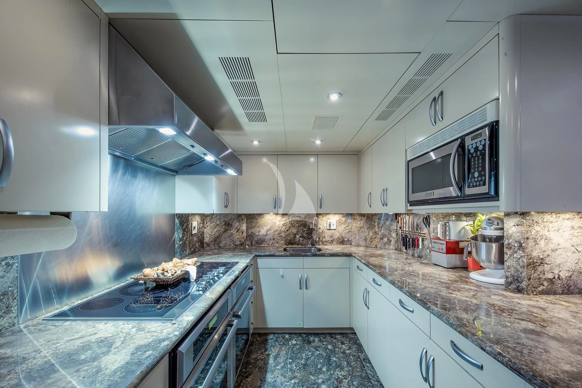 a kitchen with white cabinets aboard AMORE Yacht for Charter