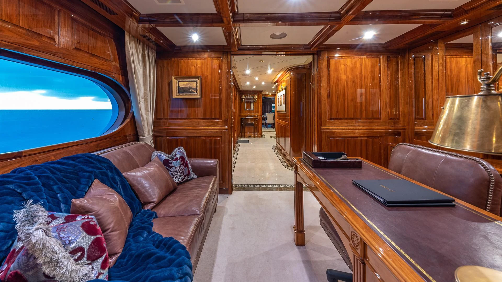 a living room with a large wood cabinet and a table aboard AMORE Yacht for Charter