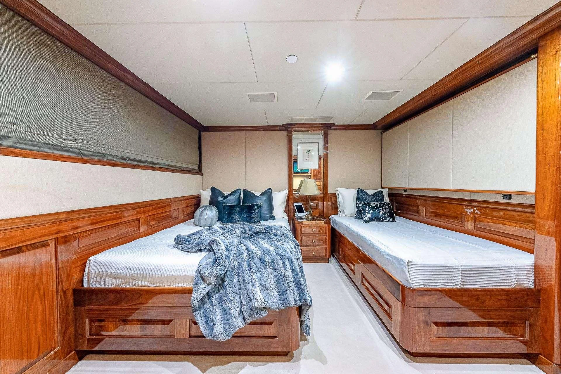 a couple of beds in a room aboard AMORE Yacht for Charter