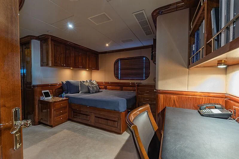 a bedroom with a bed and a desk aboard AMORE Yacht for Charter