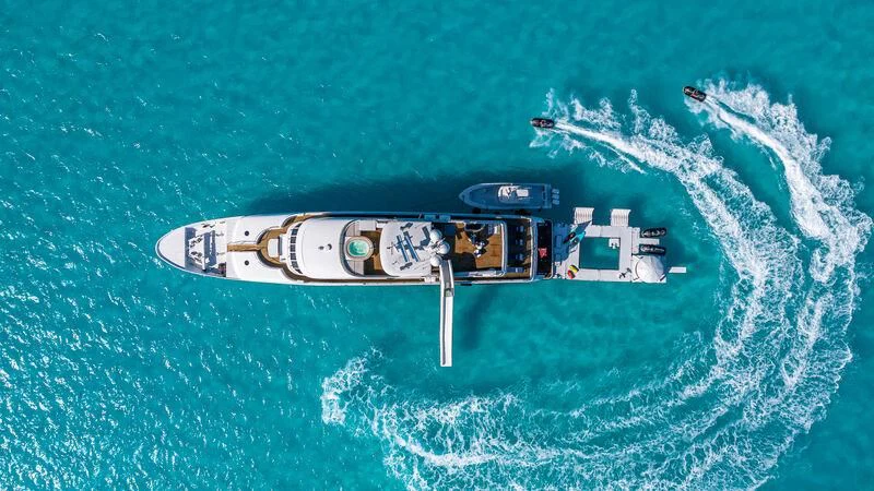 a helicopter flying over a body of water aboard AMORE Yacht for Charter