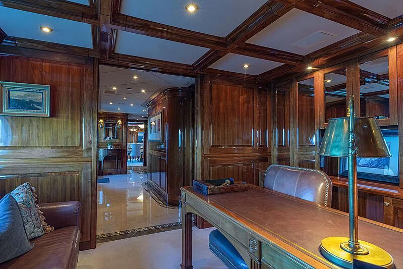 a room with a table and couch aboard AMORE Yacht for Charter
