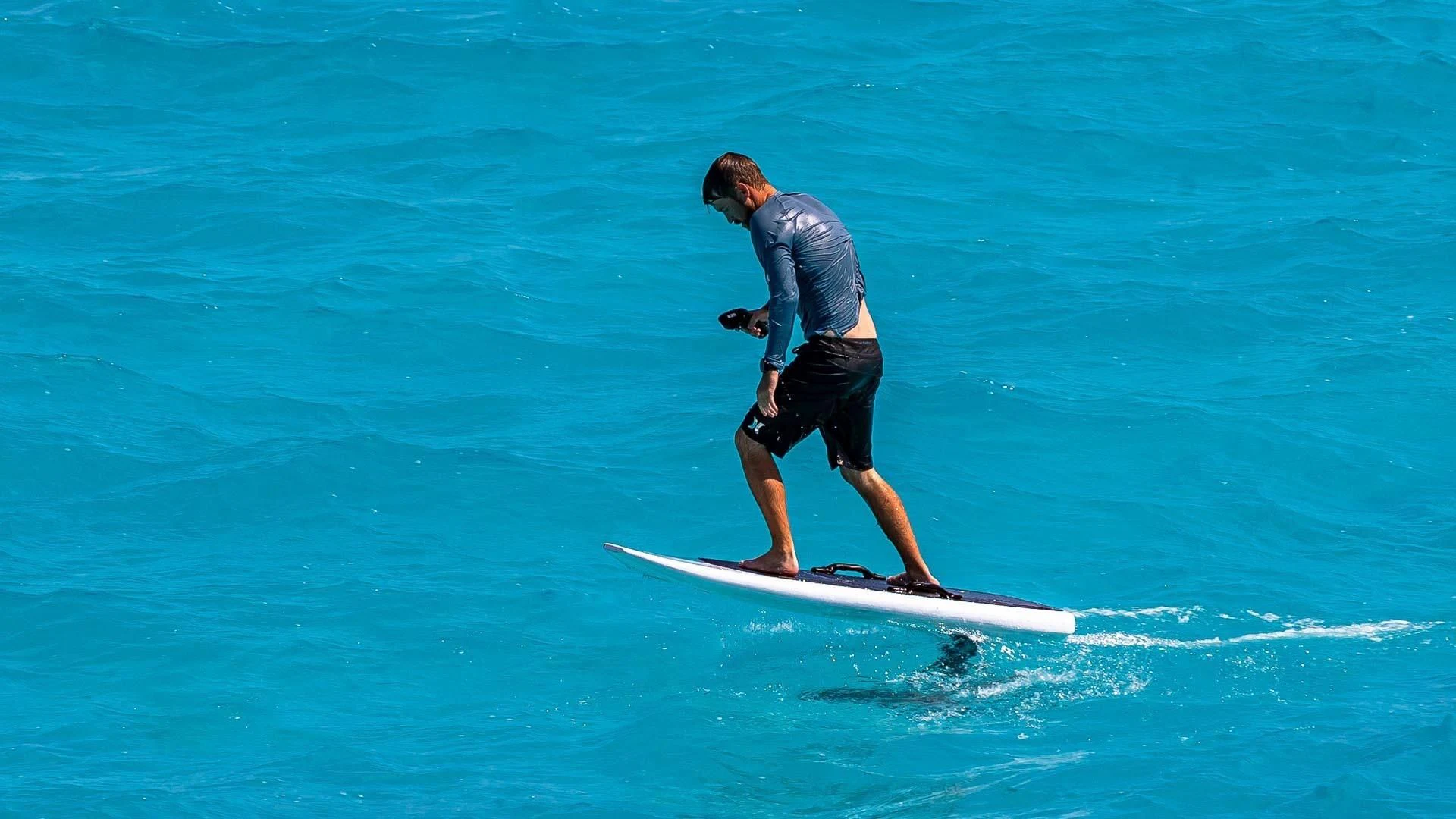 a man is water skiing aboard AMORE Yacht for Charter