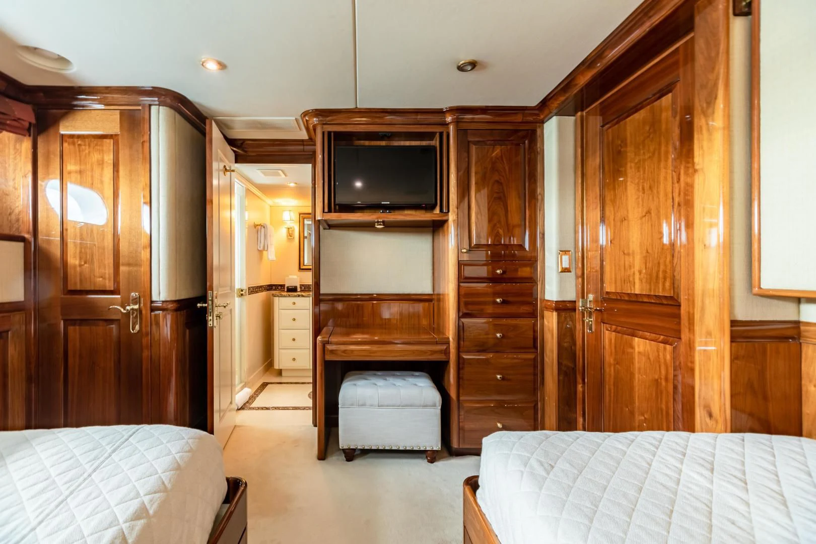 a bedroom with a bed and a television aboard AMORE Yacht for Charter