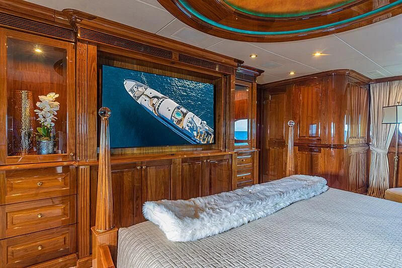 a bed with a painting on the wall aboard AMORE Yacht for Charter