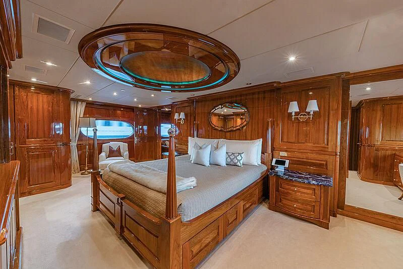 a large bedroom with a large mirror aboard AMORE Yacht for Charter
