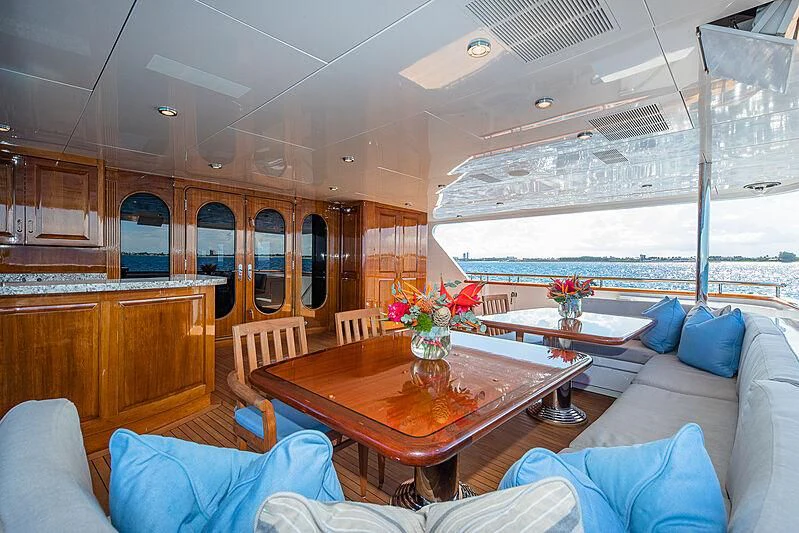 a room with a table and couches aboard AMORE Yacht for Charter