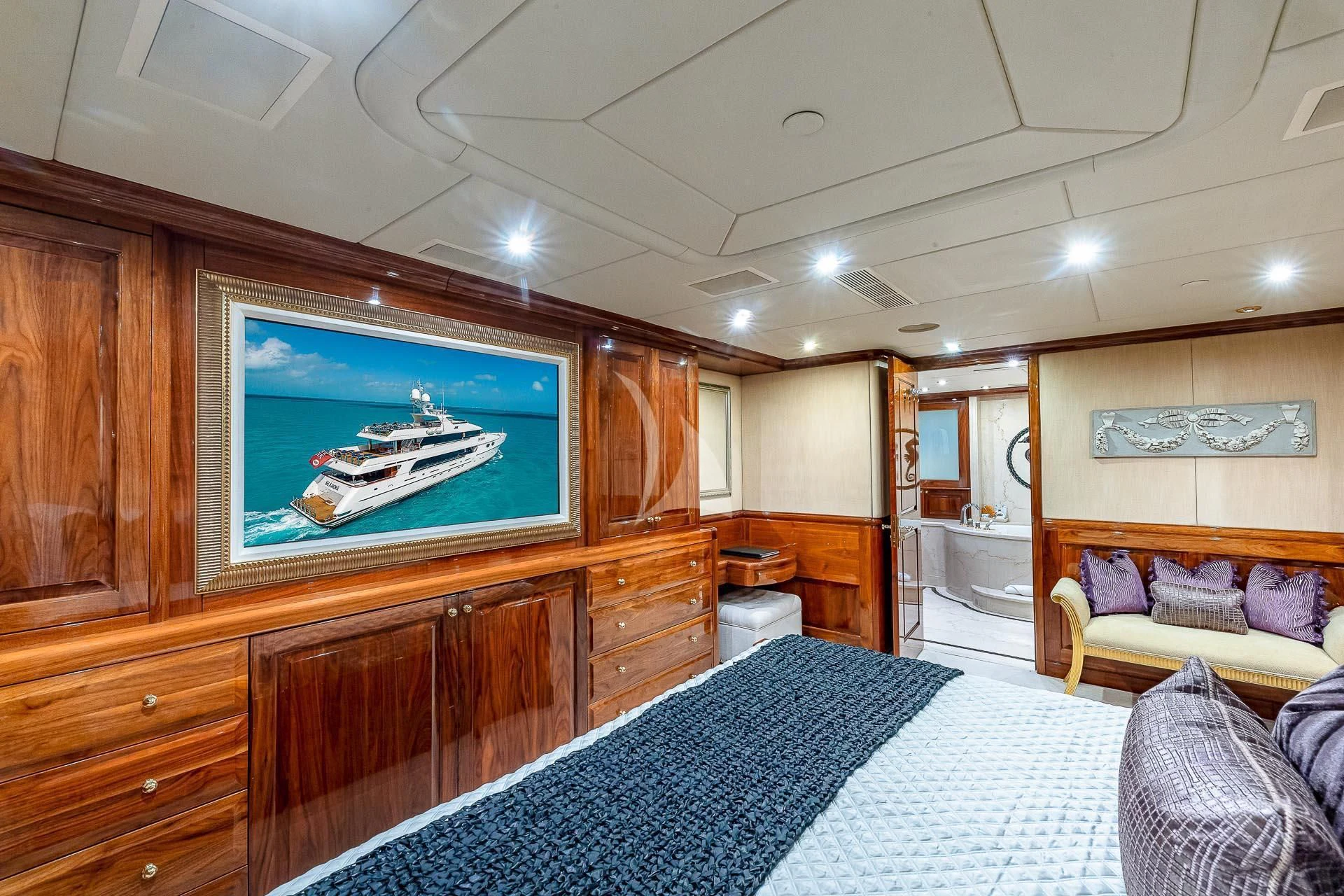 a large room with a tv and a bed aboard AMORE Yacht for Charter