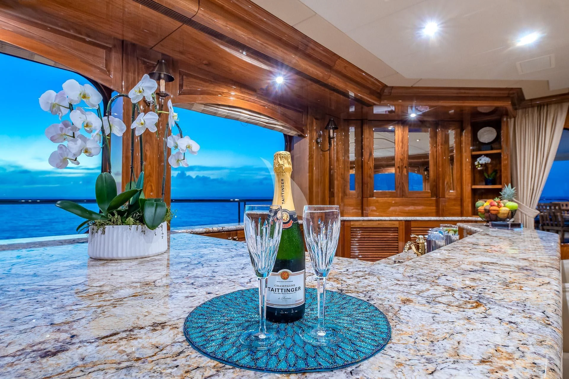 a bottle of wine on a table aboard AMORE Yacht for Charter