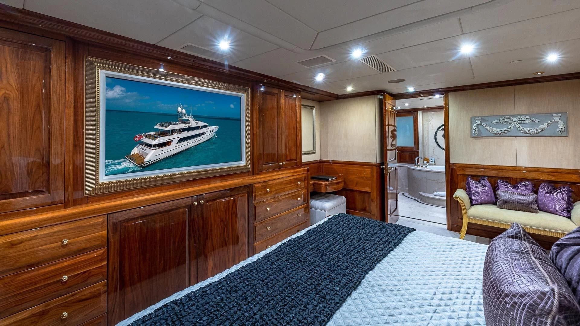 a bedroom with a large television aboard AMORE Yacht for Charter