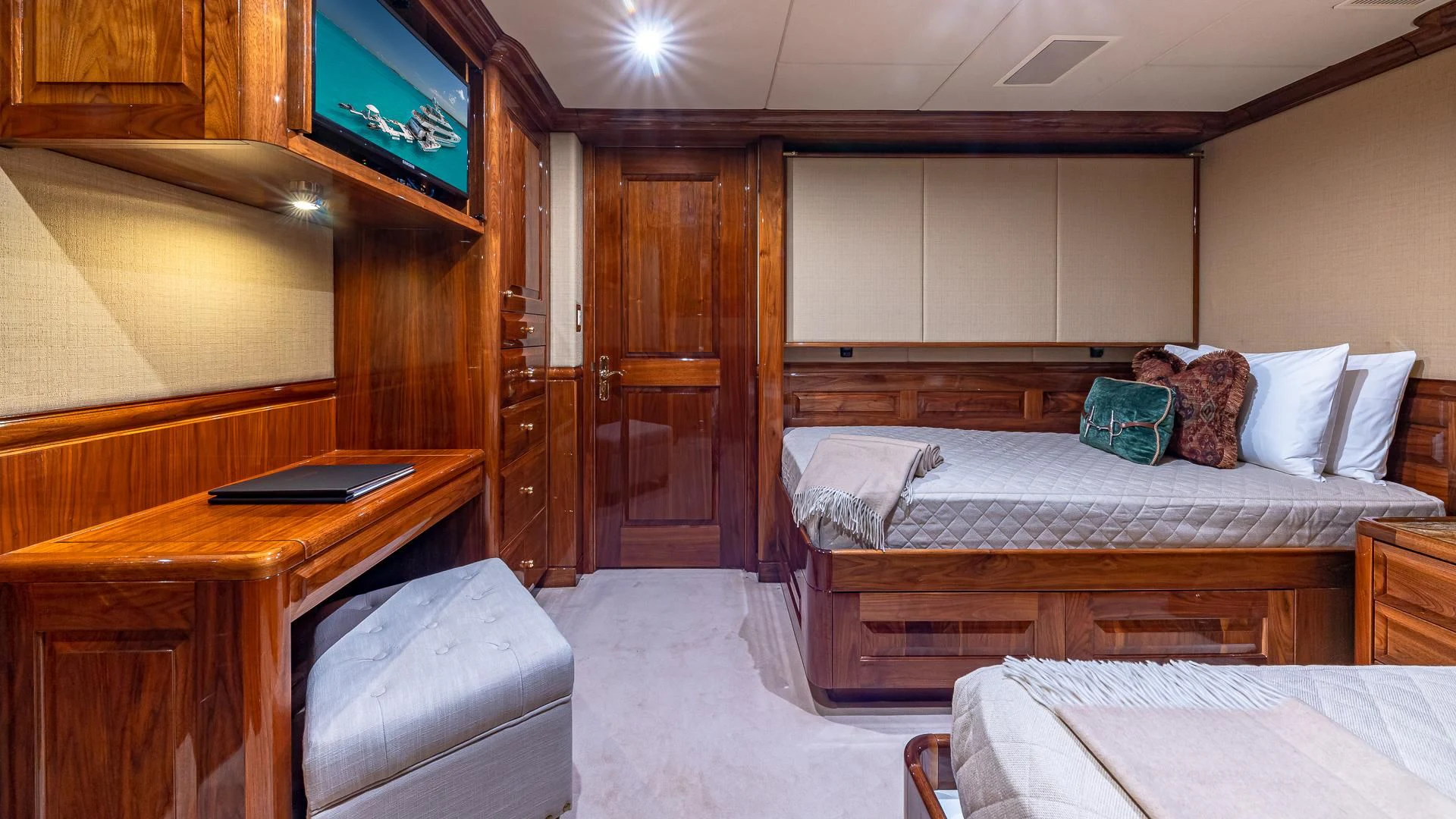 a room with a bed and a desk aboard AMORE Yacht for Charter