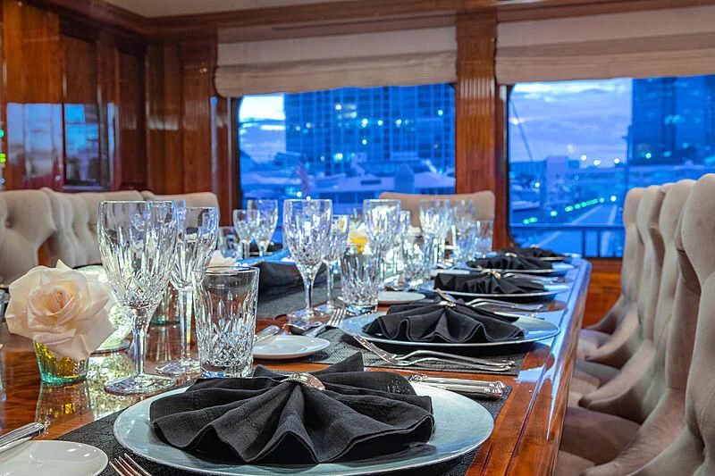 a table set with dinnerware aboard AMORE Yacht for Charter