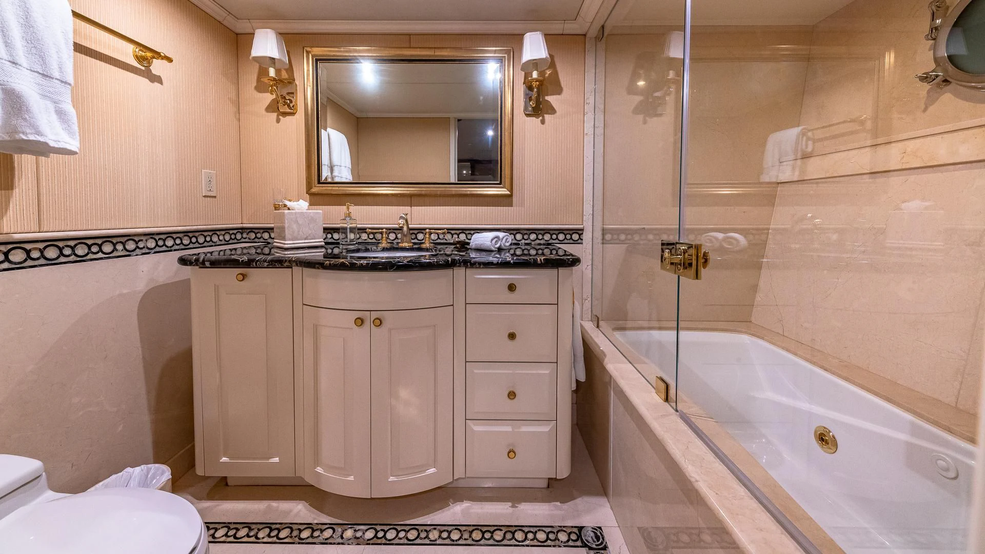a bathroom with a tub sink and cabinets aboard AMORE Yacht for Charter
