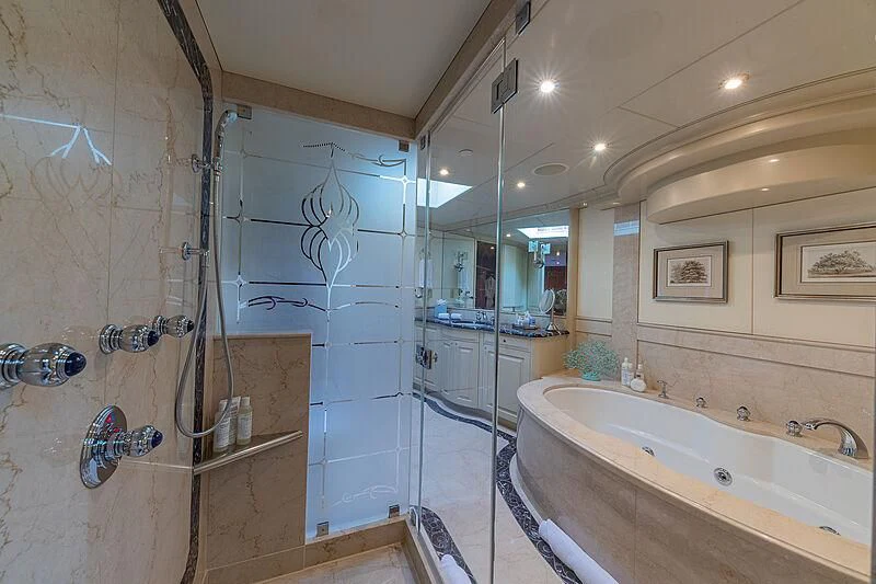 a bathroom with a bathtub and shower aboard AMORE Yacht for Charter