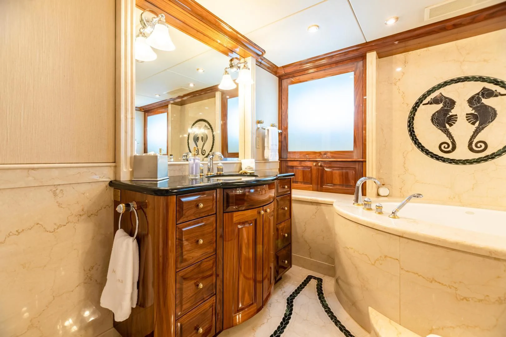 a bathroom with a tub sink and cabinets aboard AMORE Yacht for Charter