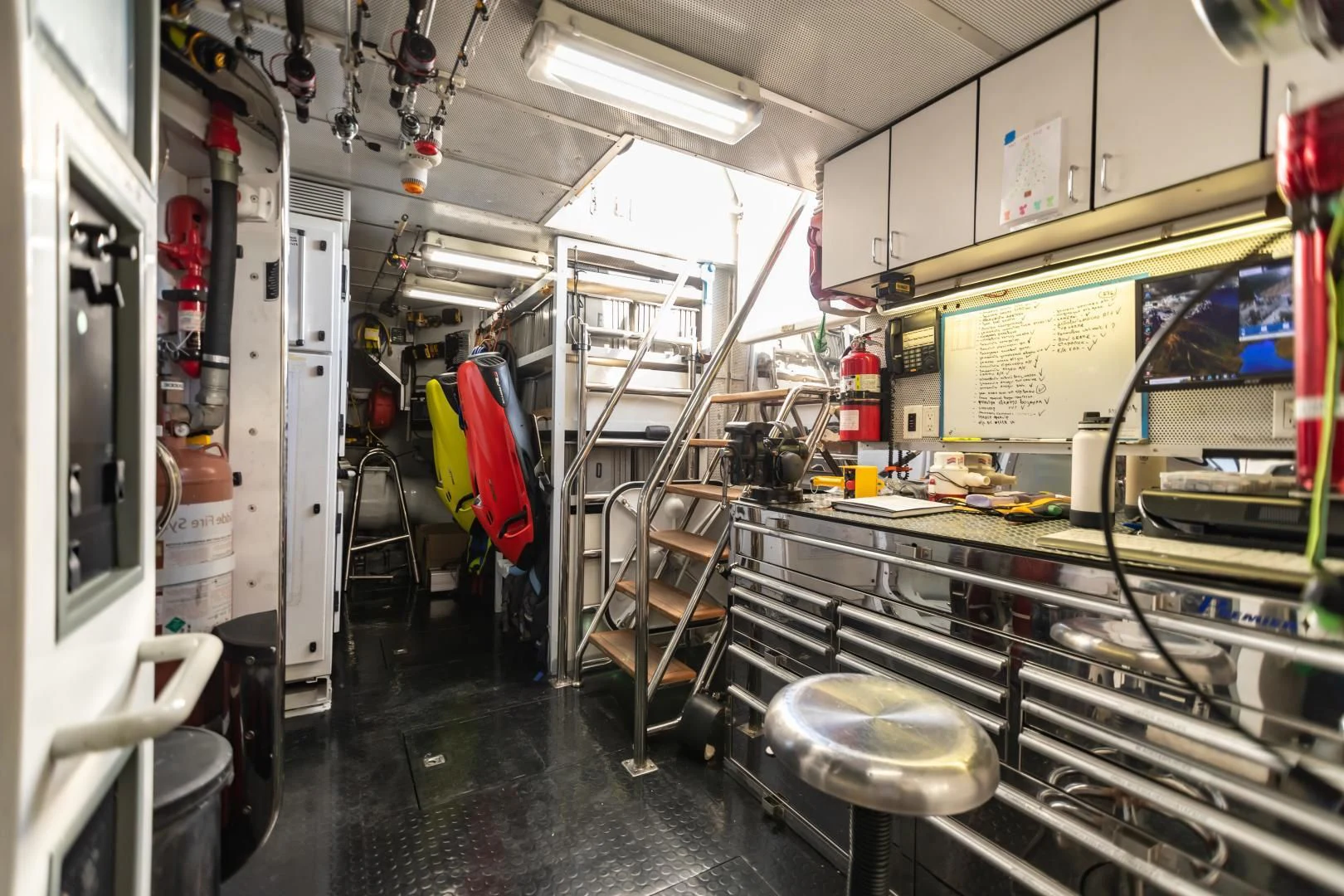 a room with tables and chairs aboard AMORE Yacht for Charter
