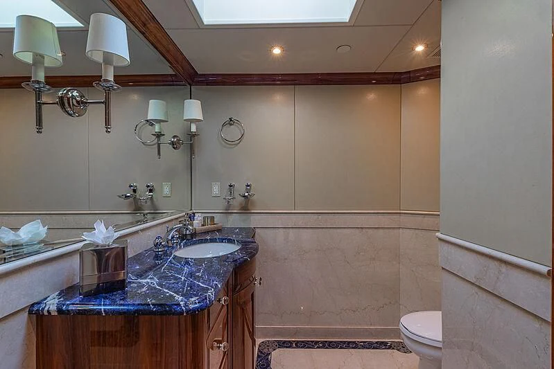 a bathroom with a countertop sink and a mirror aboard AMORE Yacht for Charter