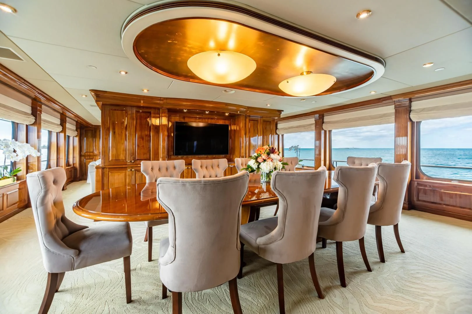a dining room with a table and chairs aboard AMORE Yacht for Charter