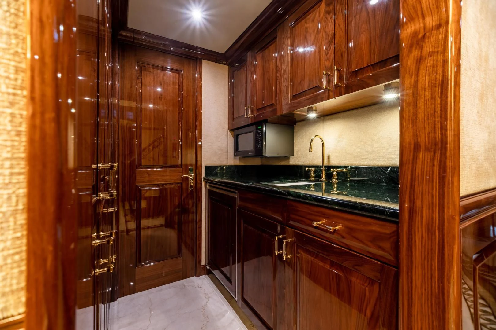 a kitchen with wooden cabinets aboard AMORE Yacht for Charter
