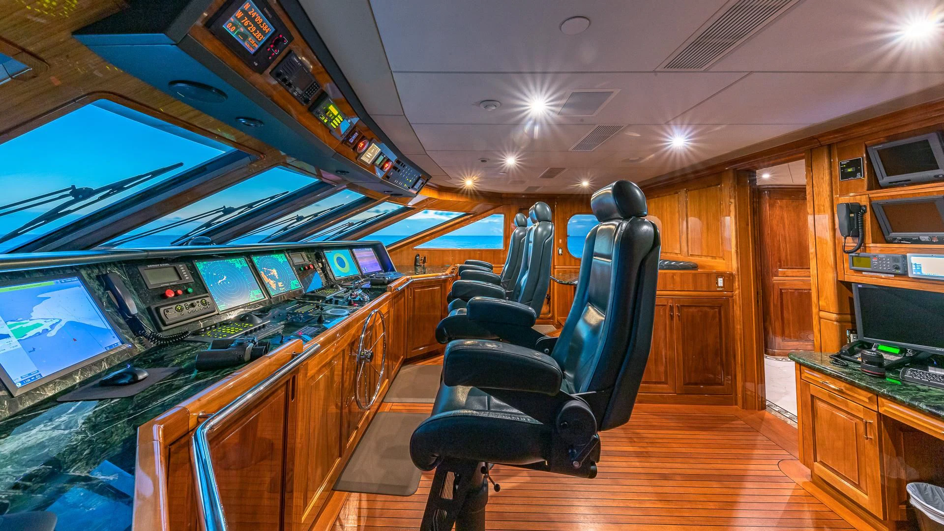 a room with a desk and chairs aboard AMORE Yacht for Charter