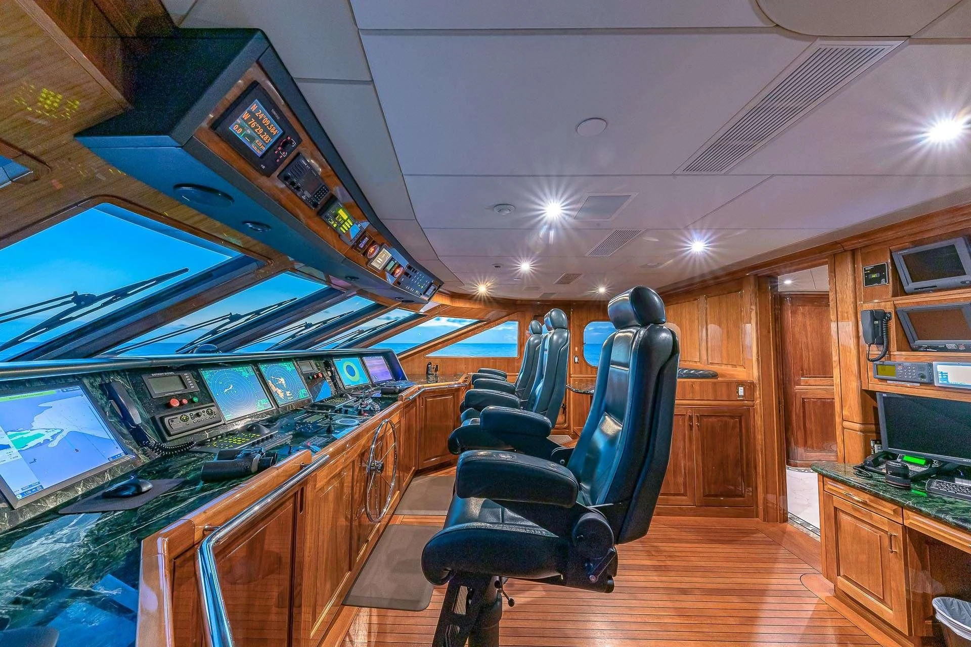a room with a desk and chairs aboard AMORE Yacht for Charter