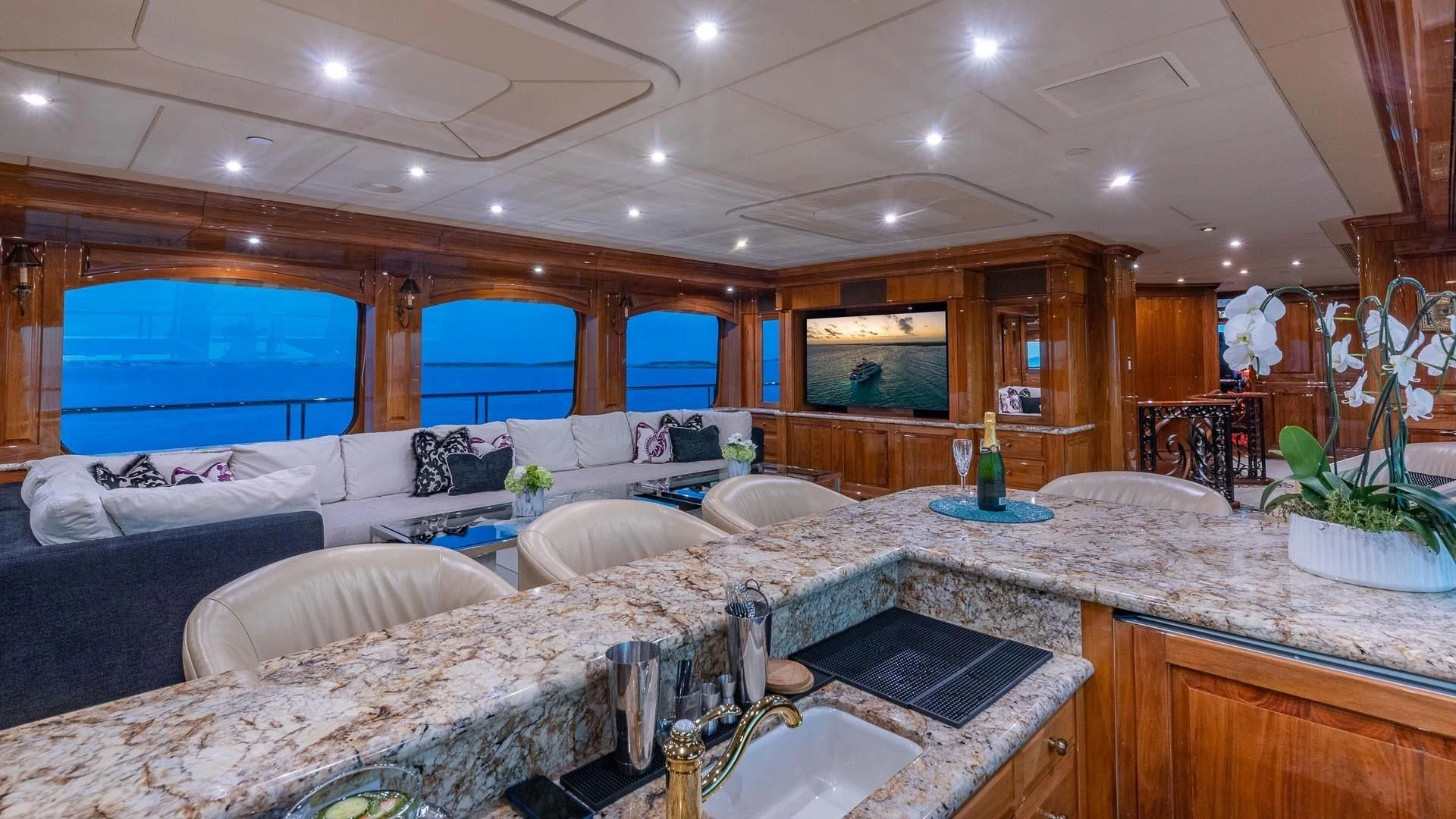 a large room with a large bed and a large television aboard AMORE Yacht for Charter