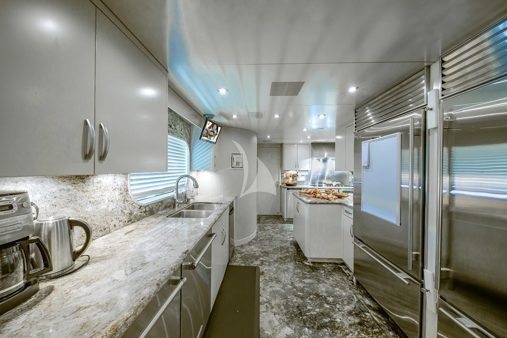 a kitchen with a sink and a refrigerator aboard AMORE Yacht for Charter