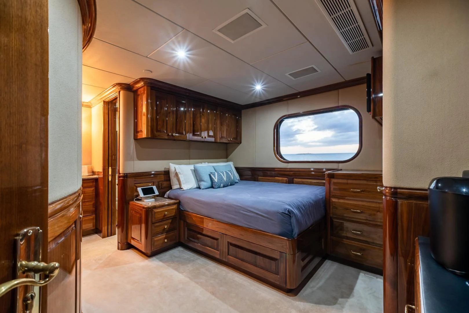 a bedroom with a bed and a window aboard AMORE Yacht for Charter