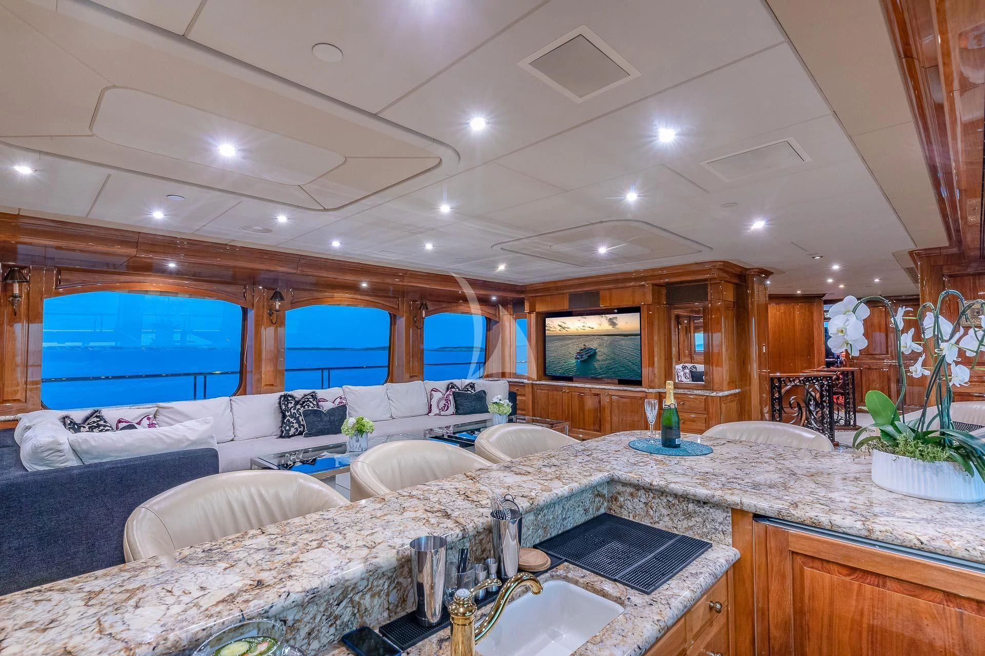a large room with a large bed and a large television aboard AMORE Yacht for Charter
