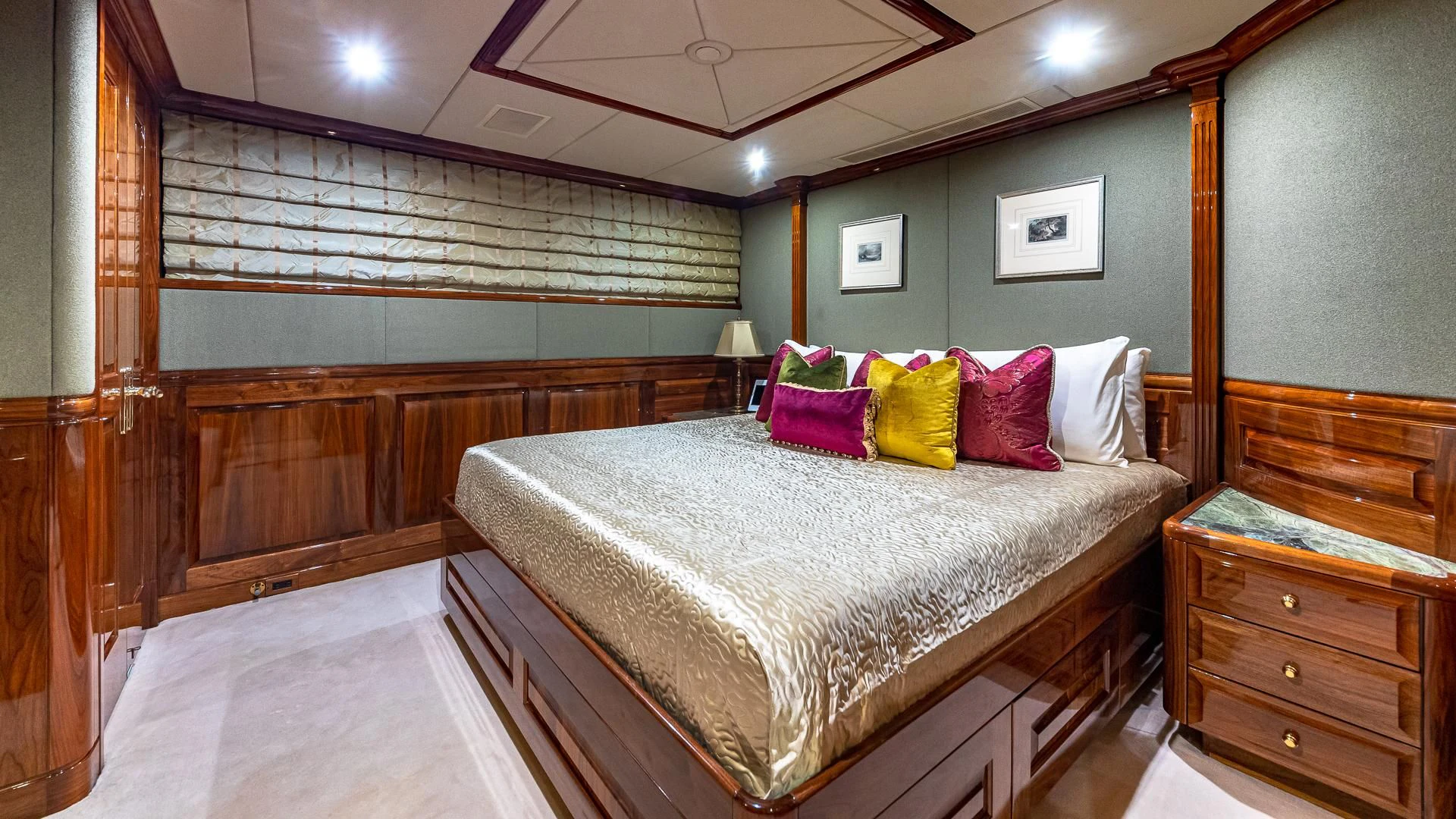 a bedroom with a bed and a dresser aboard AMORE Yacht for Charter