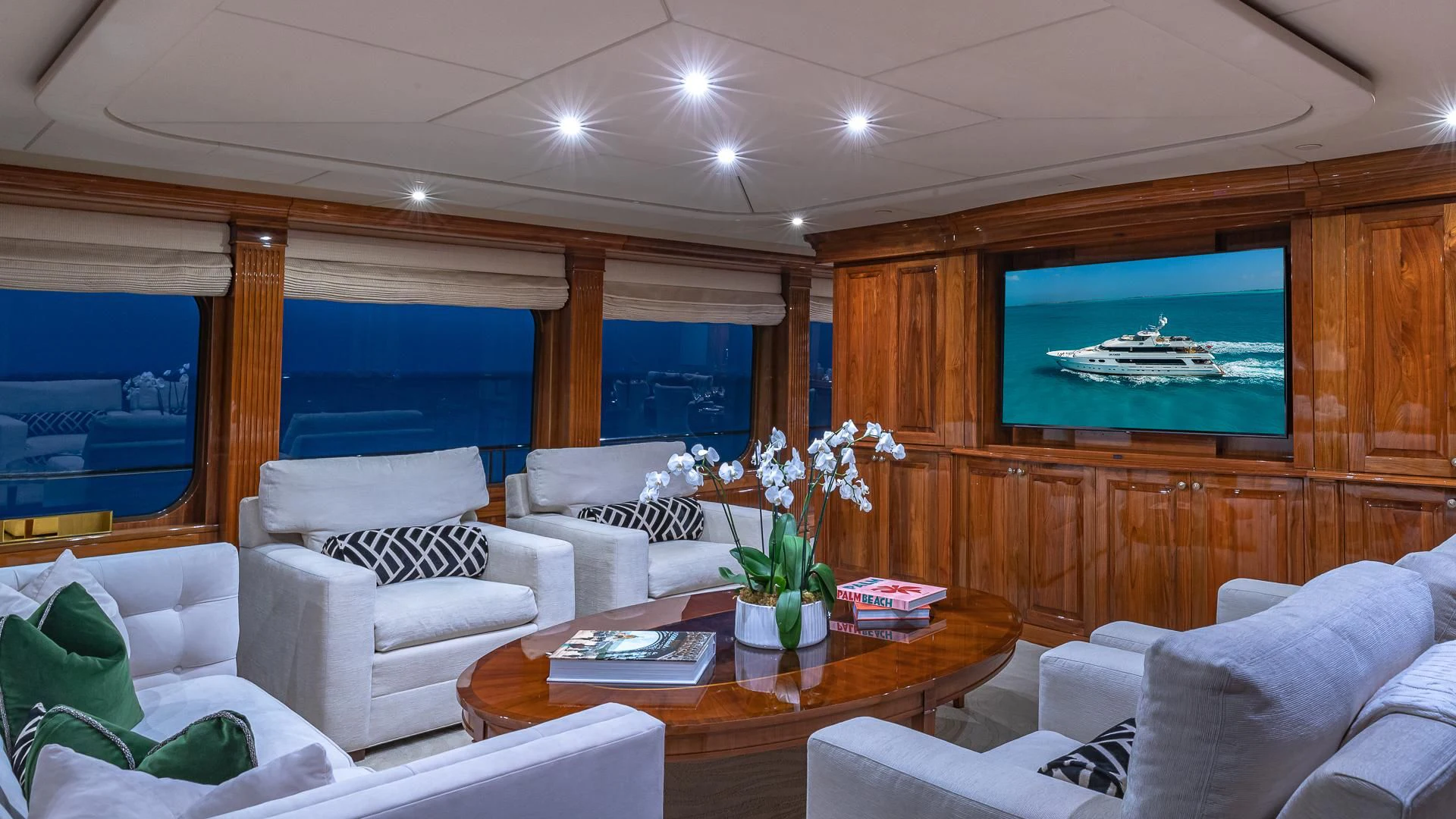 a living room with a large screen aboard AMORE Yacht for Charter
