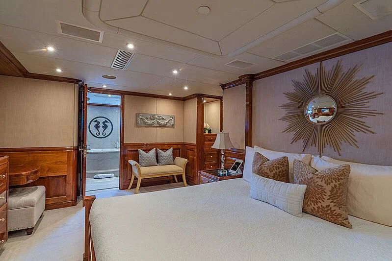 a bedroom with a bed and a chair aboard AMORE Yacht for Charter