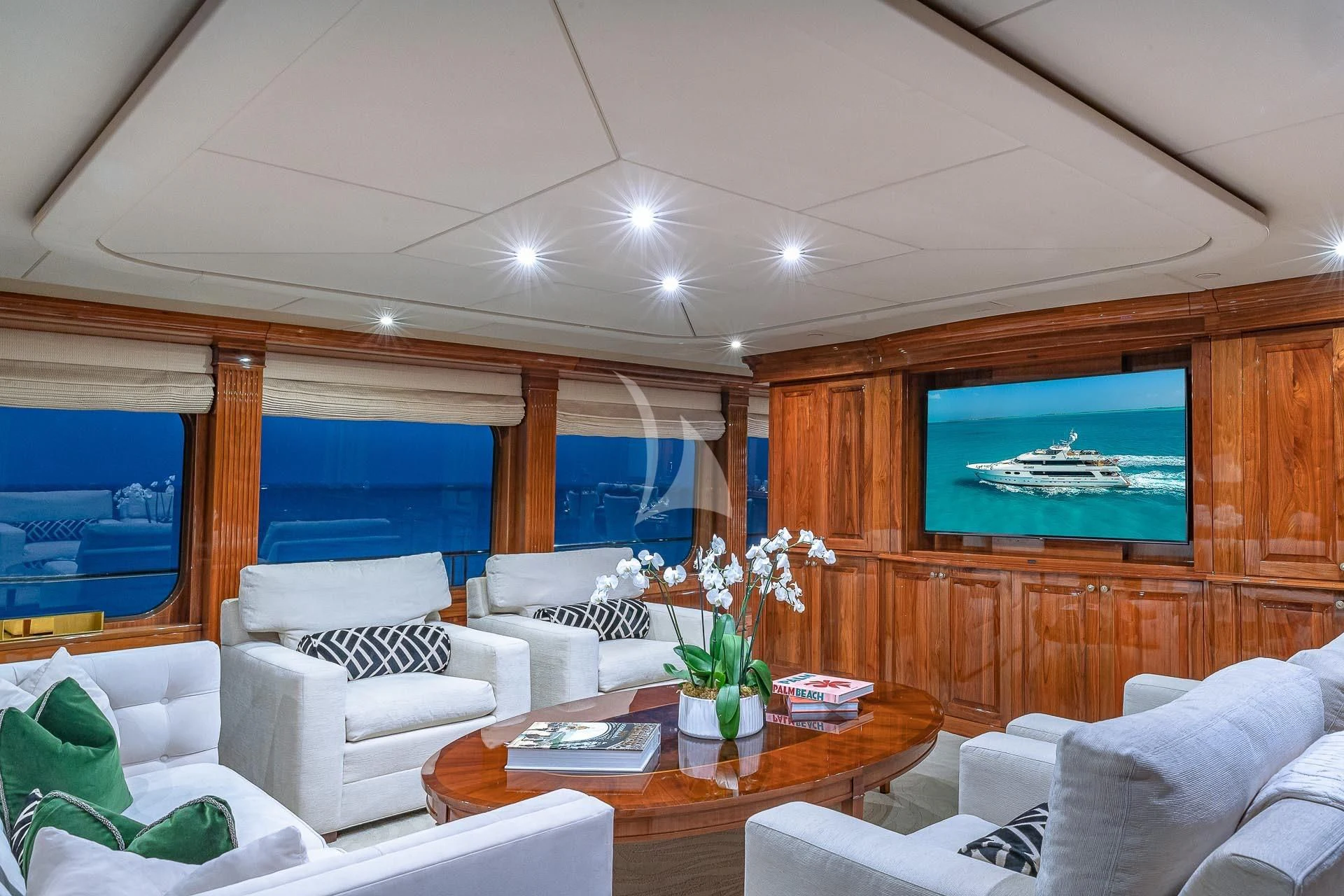 a living room with a large television aboard AMORE Yacht for Charter