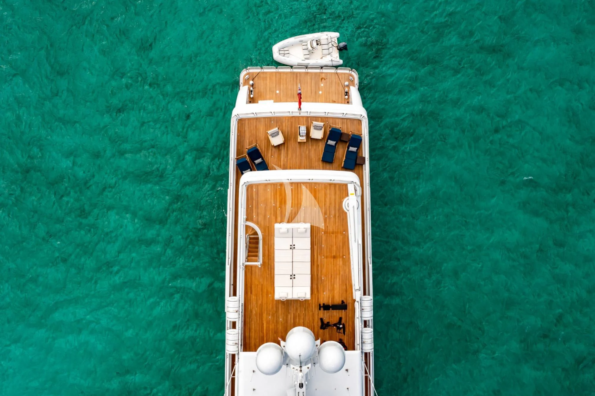 a wooden toy on a green surface aboard AMORE Yacht for Charter