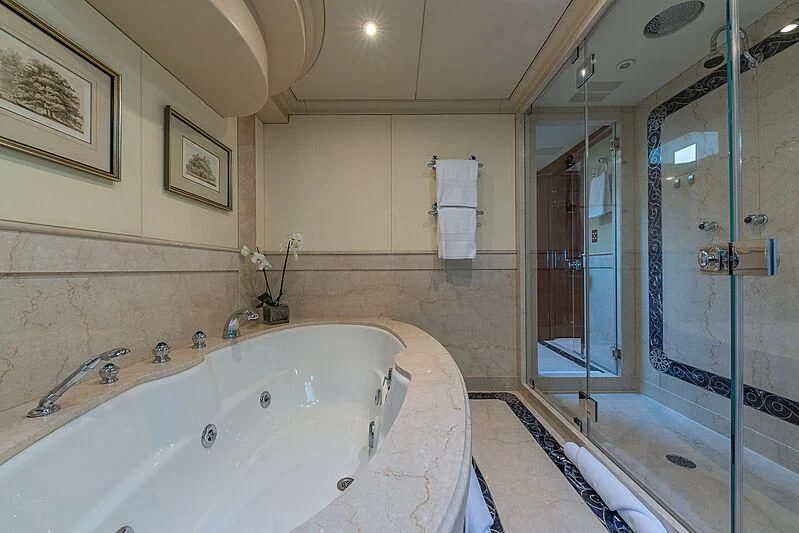 a bathroom with a bathtub and shower aboard AMORE Yacht for Charter