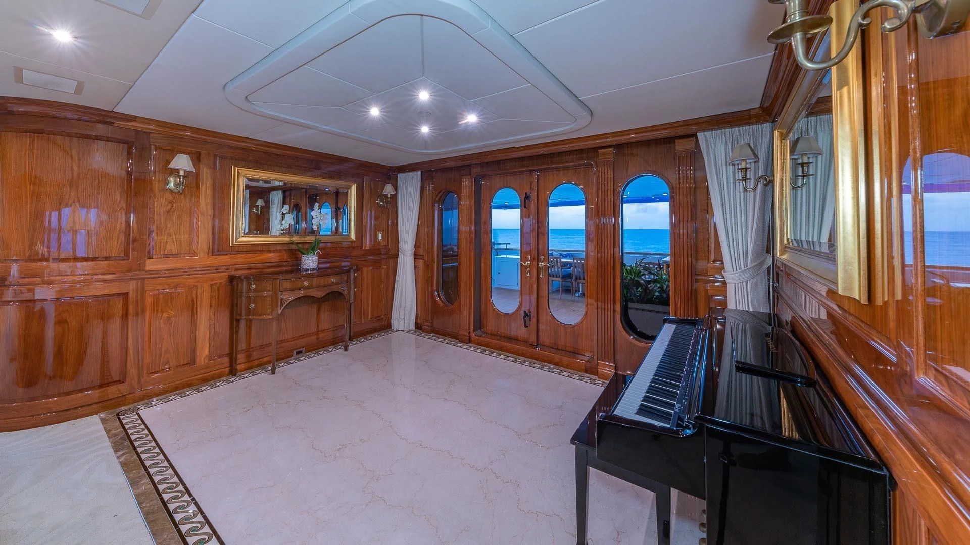 a large room with a piano and wooden cabinets aboard AMORE Yacht for Charter