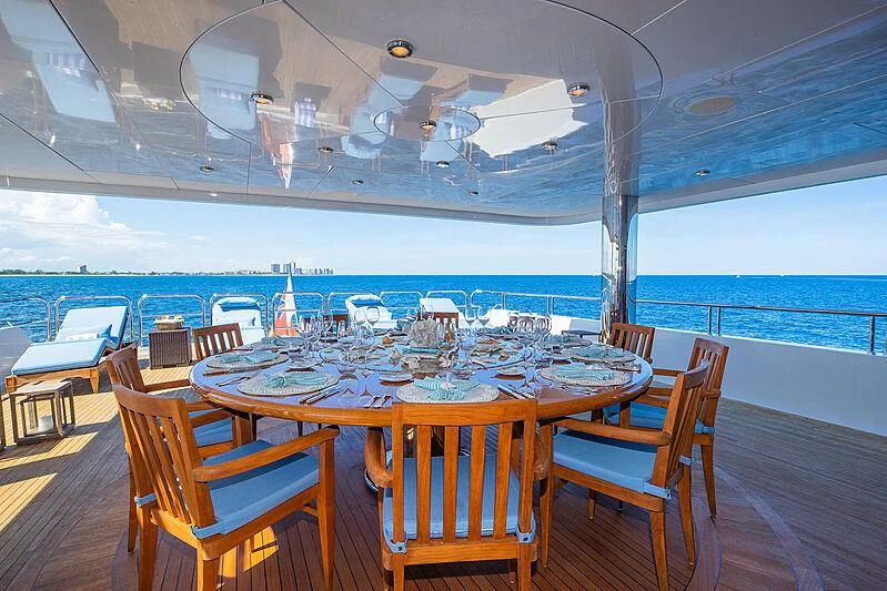 a table set for a meal on a deck aboard AMORE Yacht for Charter
