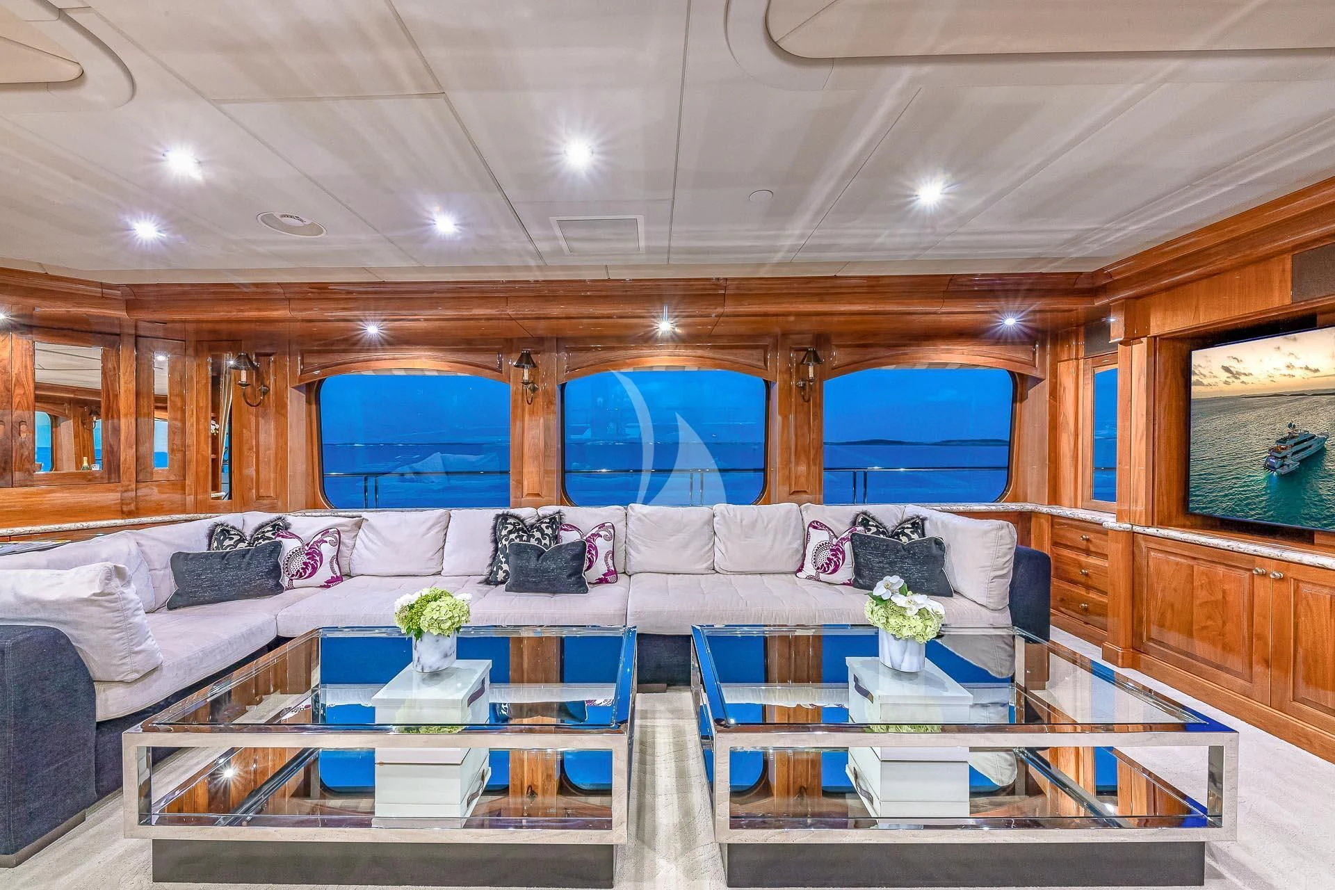 a room with a couch and a table with flowers on it aboard AMORE Yacht for Charter