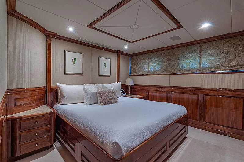 a bedroom with a bed and a ceiling fan aboard AMORE Yacht for Charter
