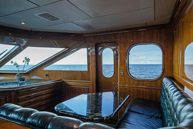 a train with a table and chairs aboard AMORE Yacht for Charter