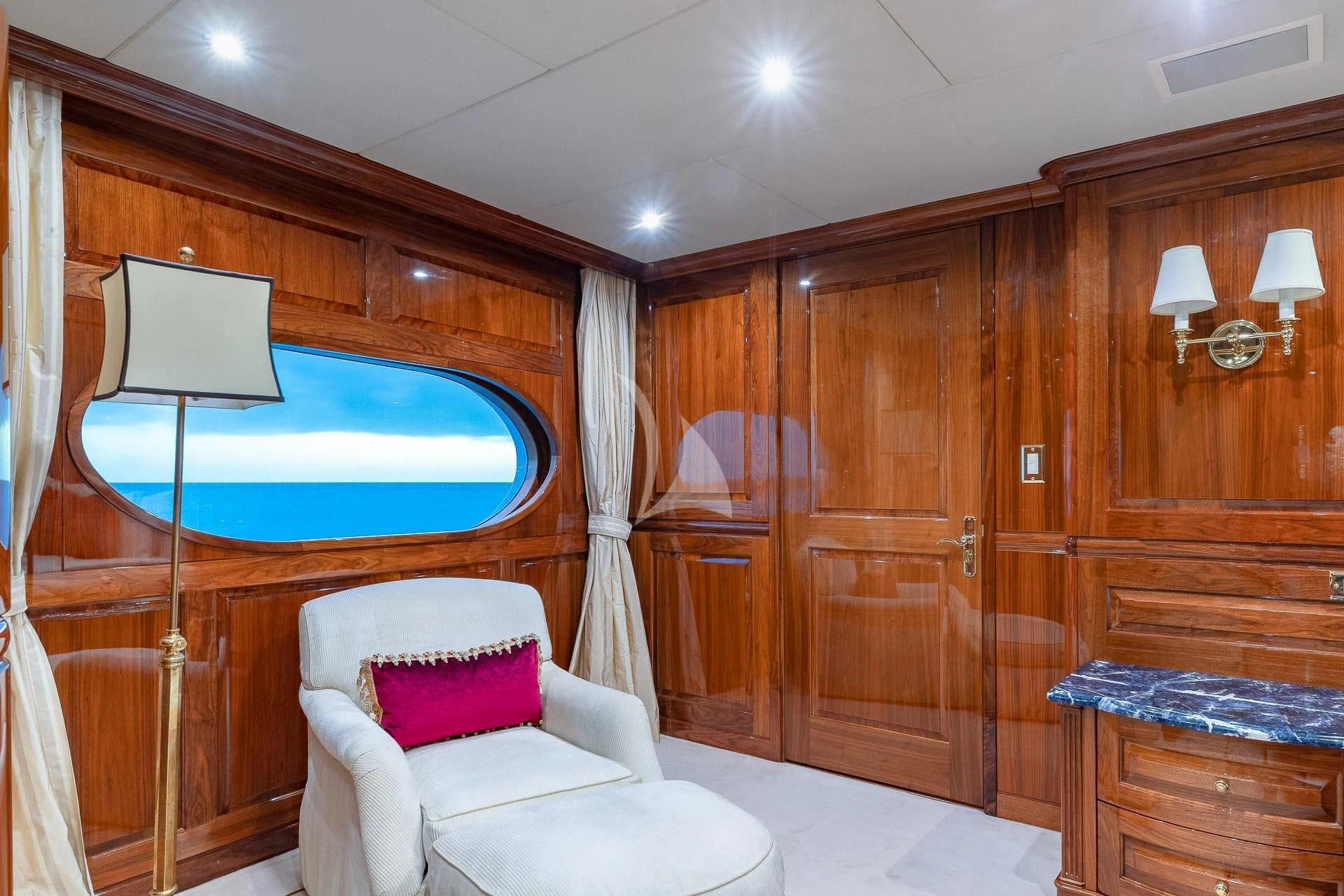 a room with a bed and a chair aboard AMORE Yacht for Charter